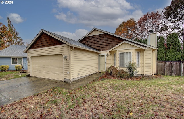 single story home with a garage and a front lawn