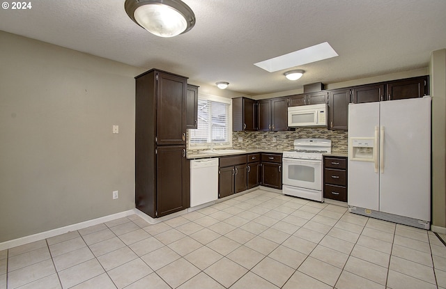 kitchen with dark brown cabinetry, white appliances, a textured ceiling, and a skylight