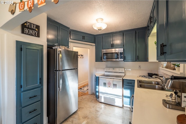 kitchen with sink, stainless steel appliances, and a textured ceiling