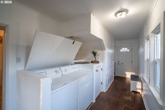 washroom with dark hardwood / wood-style floors, separate washer and dryer, a textured ceiling, and ornamental molding