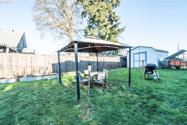 view of yard featuring a gazebo and a shed