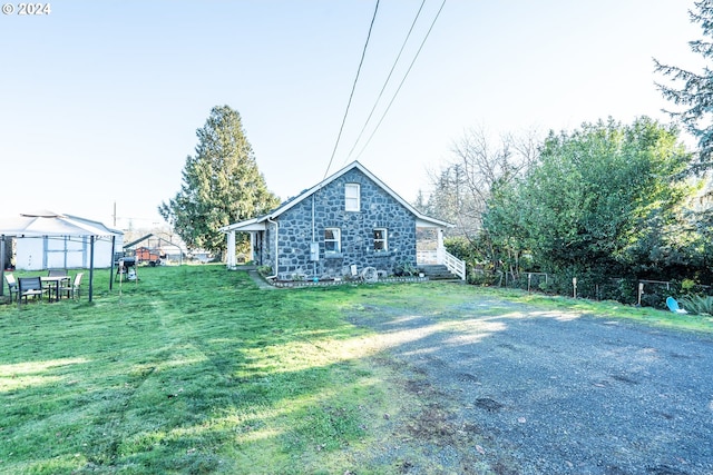 view of side of home featuring a lawn