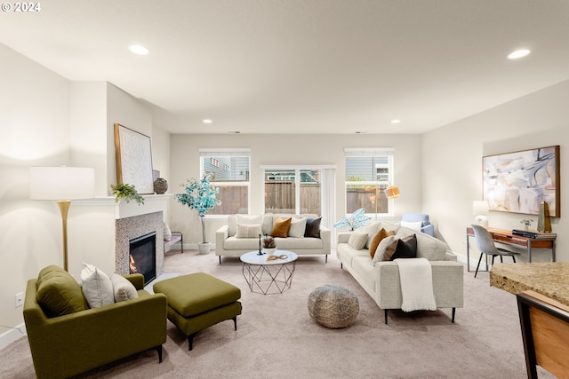 carpeted living room featuring a wealth of natural light and a tile fireplace