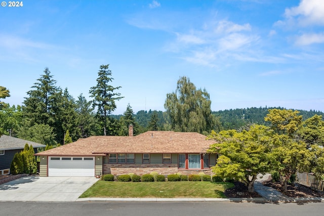 ranch-style home with a front lawn and a garage