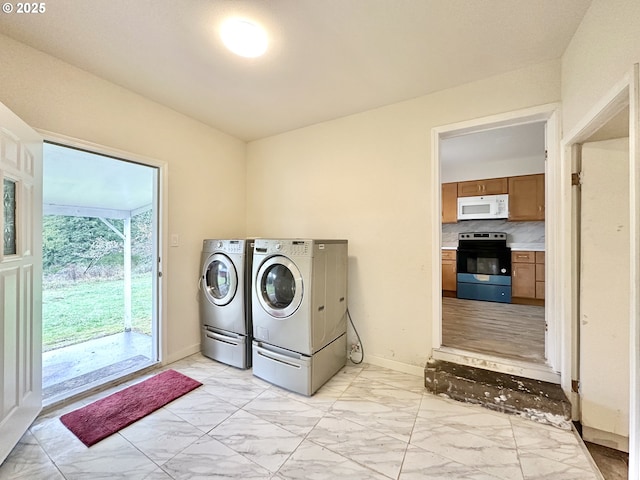 washroom featuring washer and clothes dryer