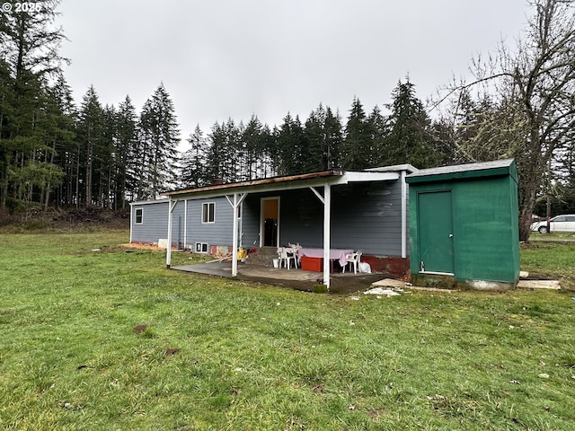 rear view of property with a yard and a patio