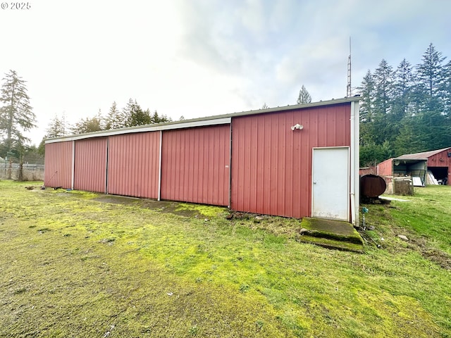 view of outbuilding featuring a lawn