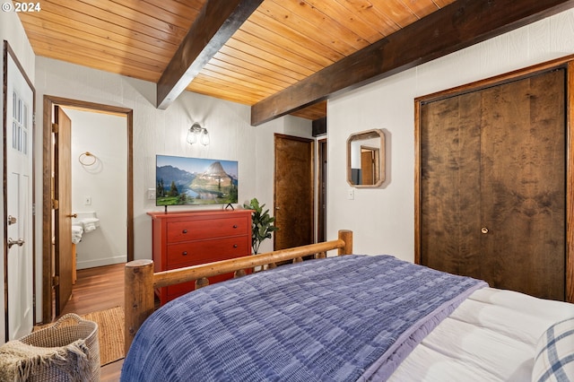 bedroom with a closet, hardwood / wood-style floors, wood ceiling, and beam ceiling