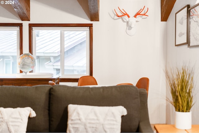 dining space with lofted ceiling with beams and plenty of natural light