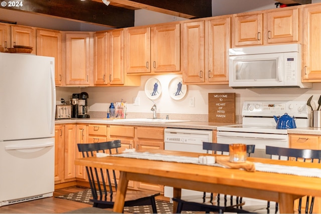 kitchen featuring white appliances and light brown cabinetry