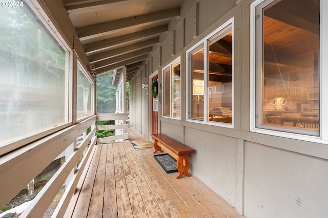 unfurnished sunroom featuring vaulted ceiling