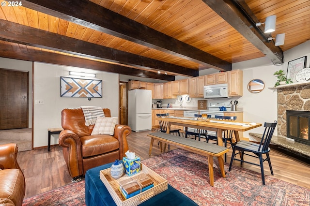 living room featuring a fireplace, light wood-type flooring, wood ceiling, and beamed ceiling