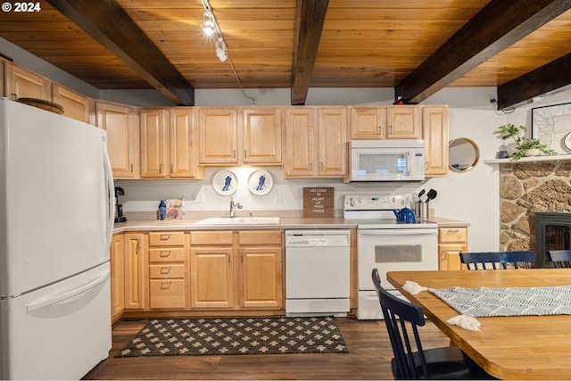 kitchen featuring white appliances, light brown cabinetry, sink, and beamed ceiling