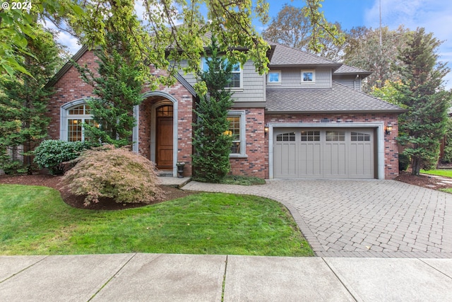 view of front of house with a garage and a front lawn