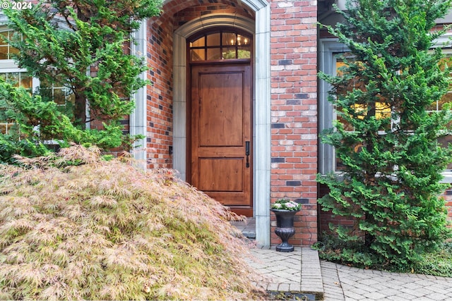 view of exterior entry with brick siding