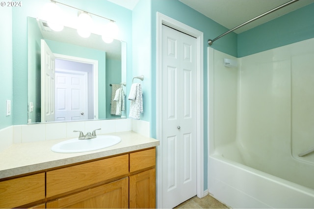 bathroom featuring  shower combination, a closet, and vanity