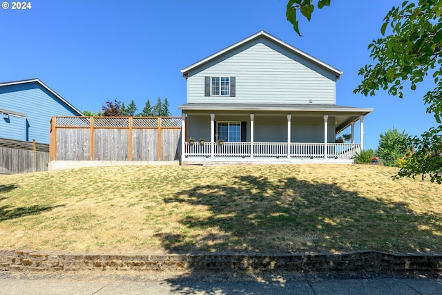 back of house featuring a yard and fence