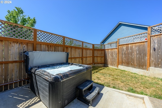 view of yard with a fenced backyard and a hot tub