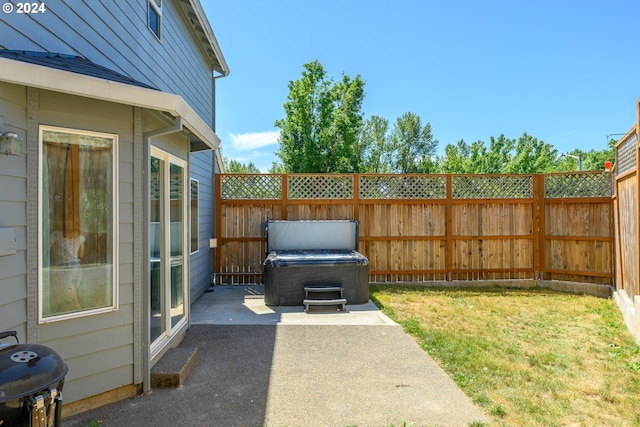 view of yard featuring a patio, a fenced backyard, and a hot tub