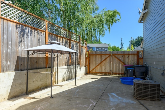 view of patio featuring a gazebo, central AC, and fence