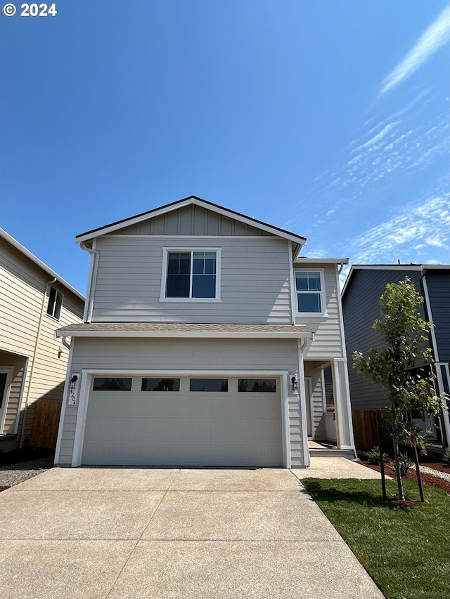 view of front of property featuring a garage and a front yard