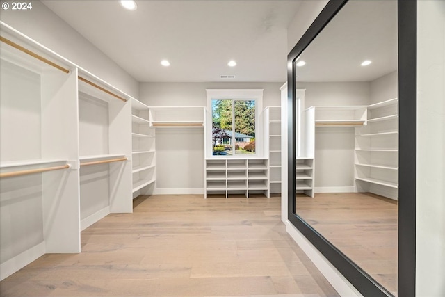 spacious closet featuring light hardwood / wood-style flooring