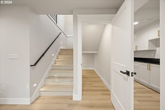 stairs featuring wood-type flooring