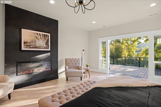 bedroom featuring access to outside and a notable chandelier