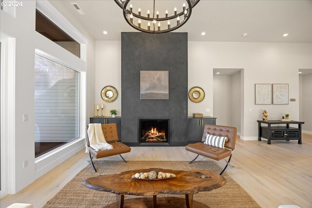 bedroom featuring access to outside, a notable chandelier, and light hardwood / wood-style flooring