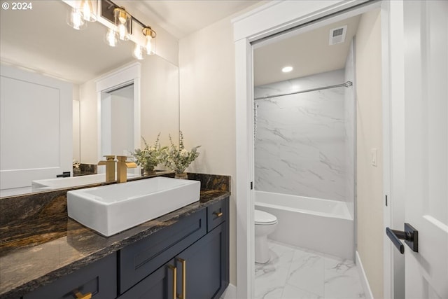 full bathroom featuring vanity, tiled shower / bath combo, and toilet