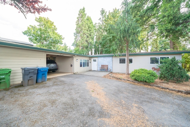 view of front of home featuring driveway and an attached carport