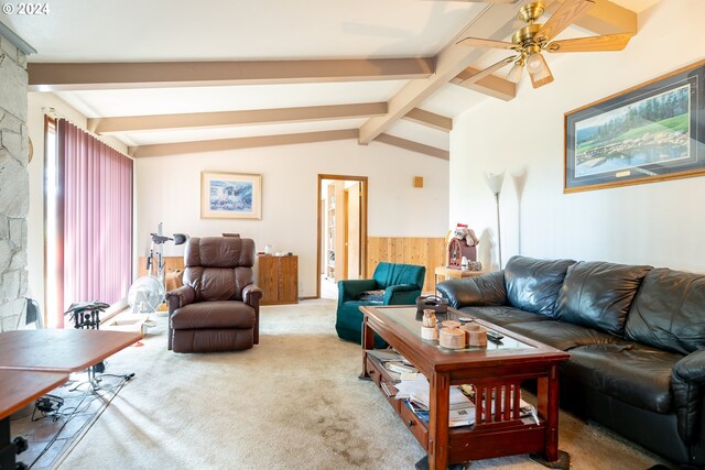 carpeted living room with a wealth of natural light, ceiling fan, and vaulted ceiling with beams