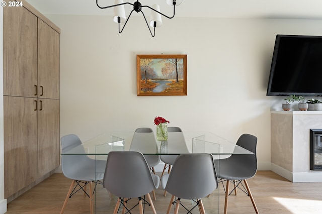 dining room featuring a chandelier and light hardwood / wood-style flooring