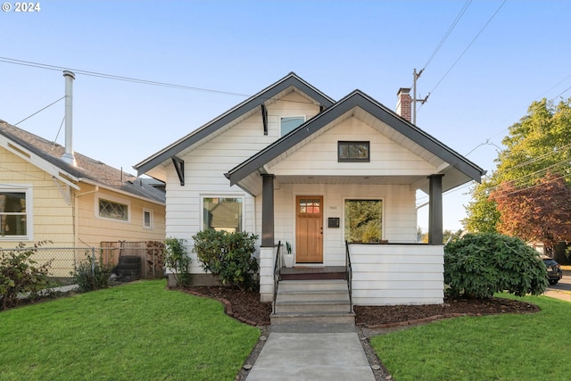 bungalow-style home featuring a front lawn