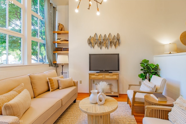 living room with hardwood / wood-style flooring and a chandelier