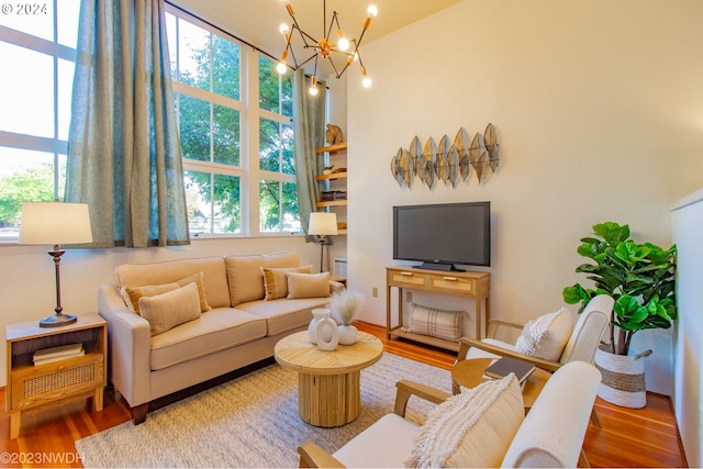 living room with hardwood / wood-style floors and a notable chandelier