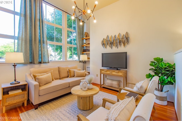 living area featuring a chandelier, wood finished floors, and plenty of natural light