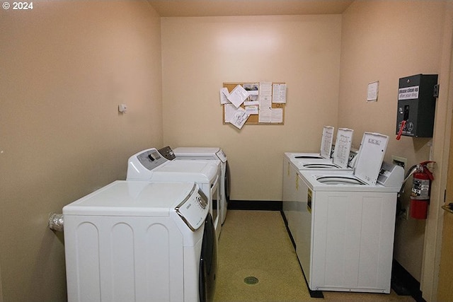 laundry area with independent washer and dryer and electric panel