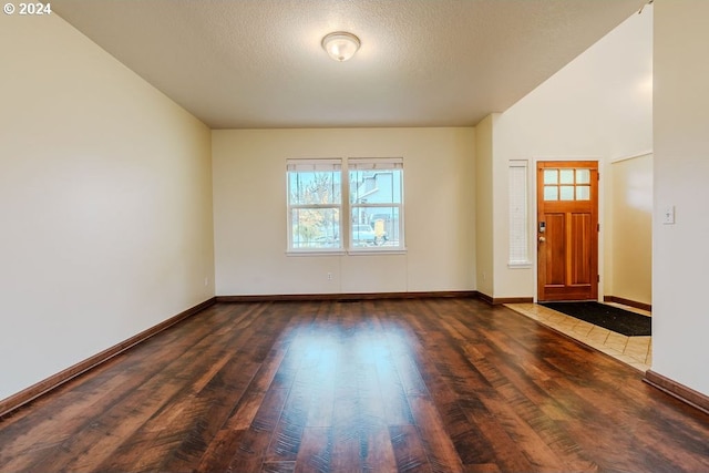 entryway featuring a textured ceiling and dark hardwood / wood-style flooring