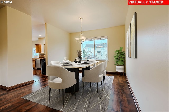 dining room with dark hardwood / wood-style flooring and a notable chandelier