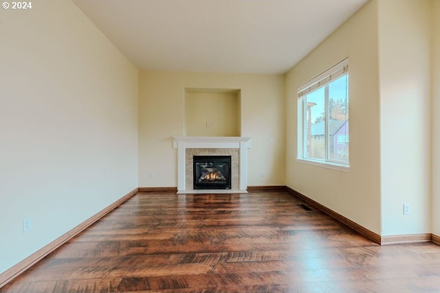 unfurnished living room with a fireplace and dark hardwood / wood-style flooring