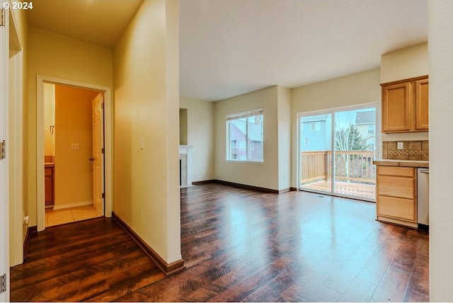 interior space with dark wood-type flooring and a healthy amount of sunlight