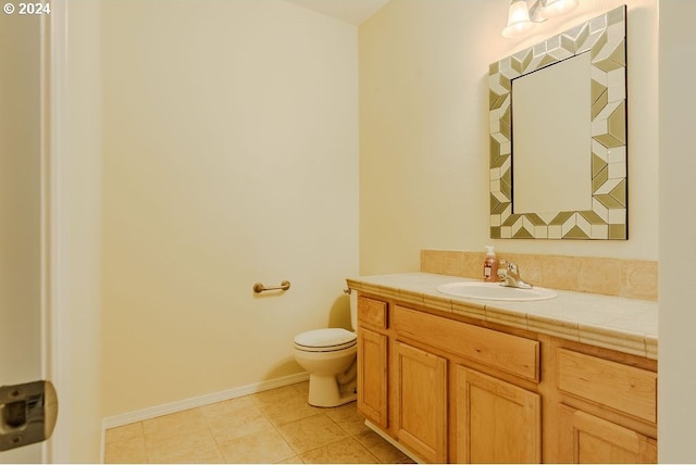 bathroom featuring toilet, vanity, and tile patterned flooring