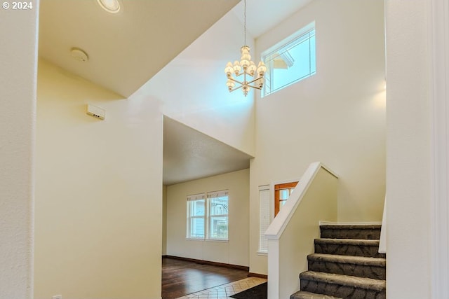 staircase with an inviting chandelier and hardwood / wood-style floors