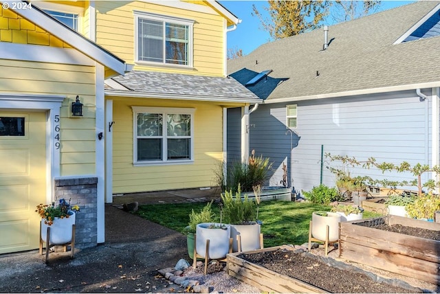 back of house featuring a garage