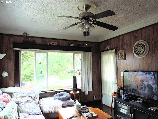 living room with a wealth of natural light and wooden walls