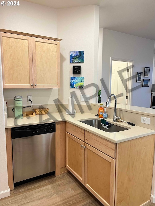 kitchen with sink, light hardwood / wood-style flooring, stainless steel dishwasher, kitchen peninsula, and light brown cabinetry