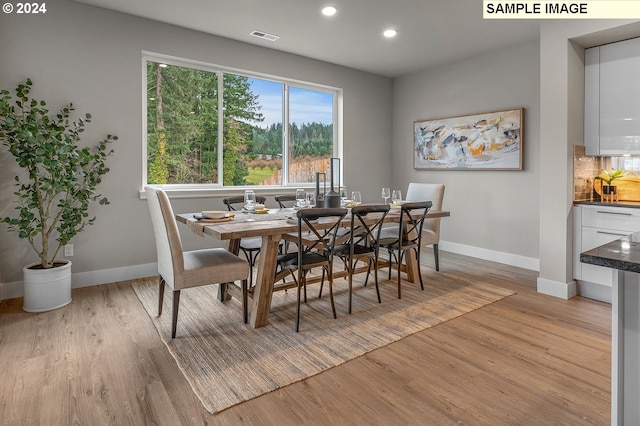 dining space with light wood-type flooring