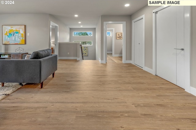 hallway with light hardwood / wood-style floors