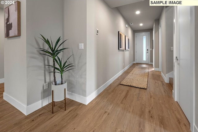 hall with hardwood / wood-style floors